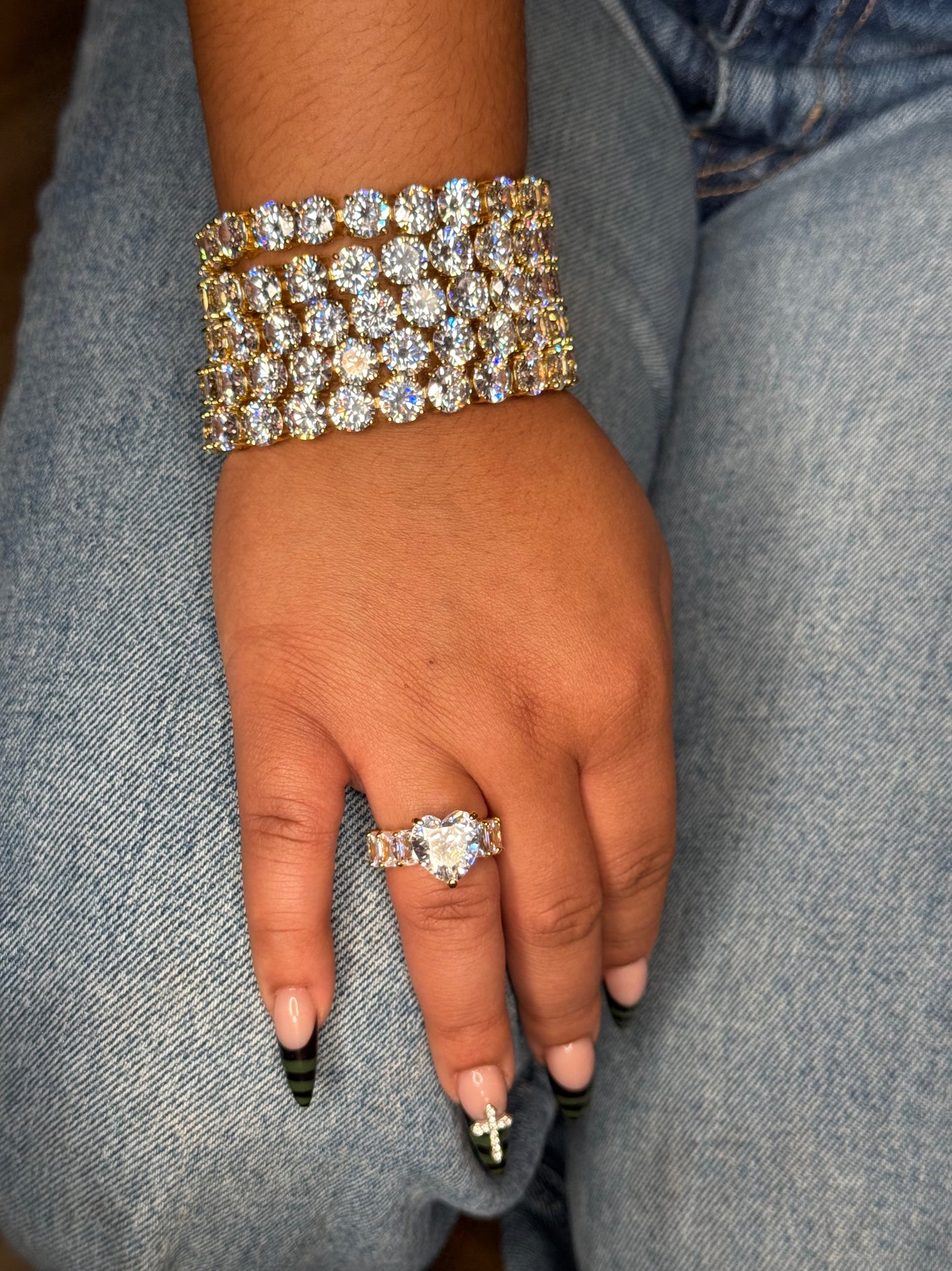 Bracelet worn on wrist: THE AFTER HOURS tennis bracelet shown in gold and gold heiress ring worn