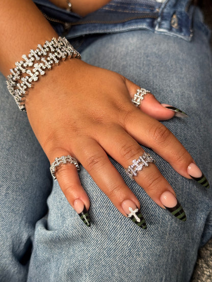  THE ENIGMA checkered open cross statement ring worn on finger in silver